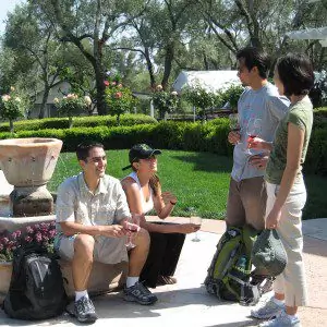 Group of people taste wine surrounding fountain